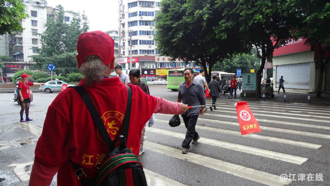图为志愿者在指挥行人过公路4.png